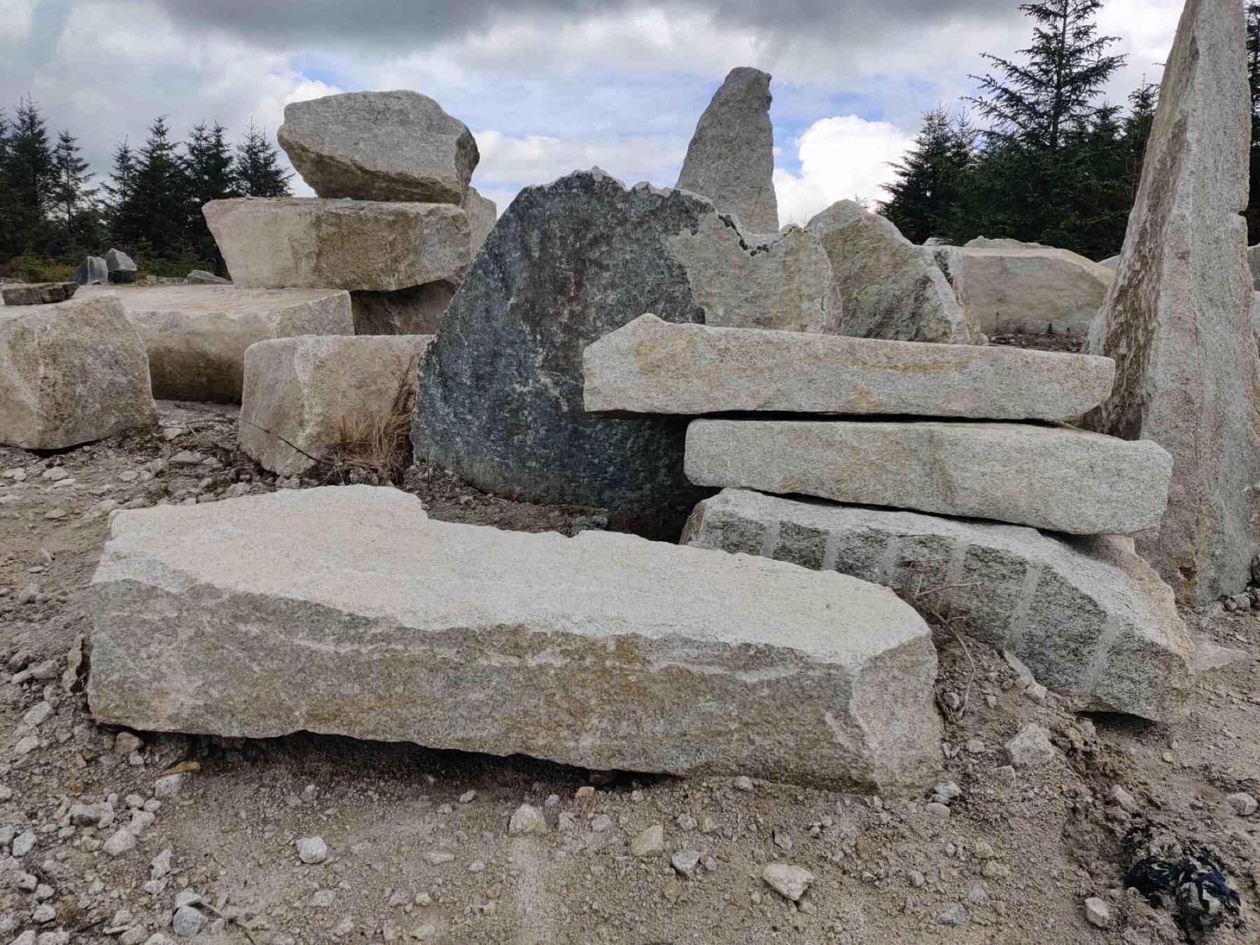 A granite boulder water feature in a landscaped garden