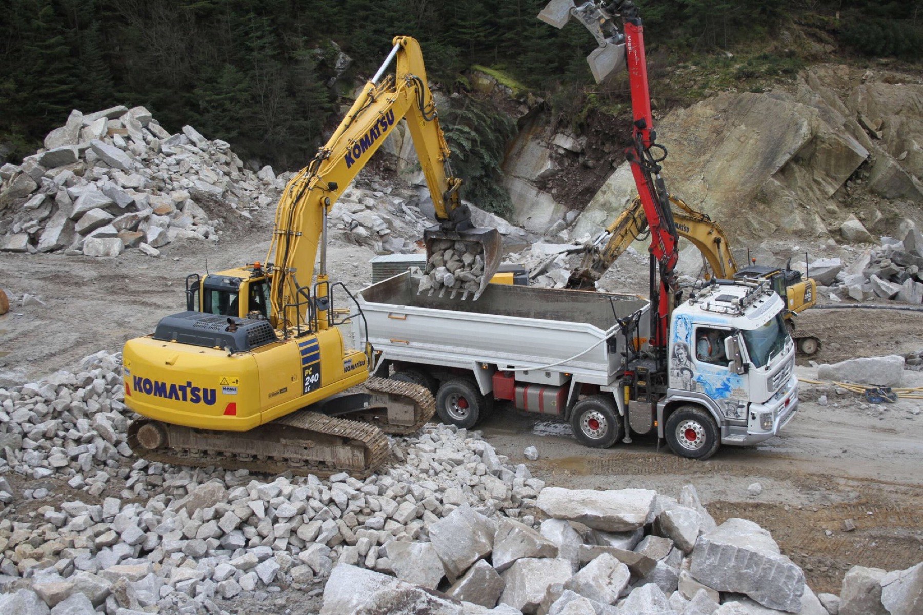 Excavators loading crushed granite at the quarry